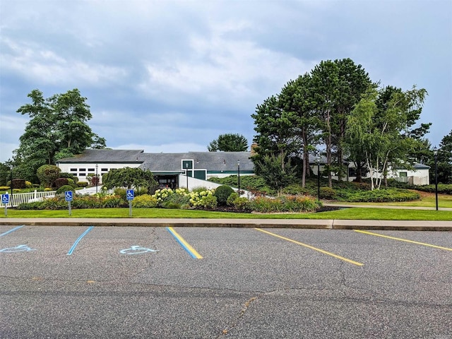 uncovered parking lot featuring fence