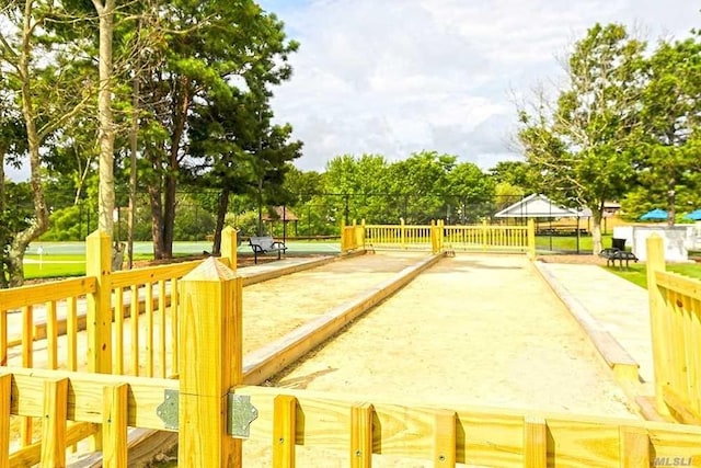 view of home's community featuring fence