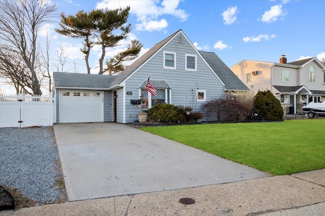 view of front of house featuring fence, driveway, a shingled roof, a front lawn, and a garage