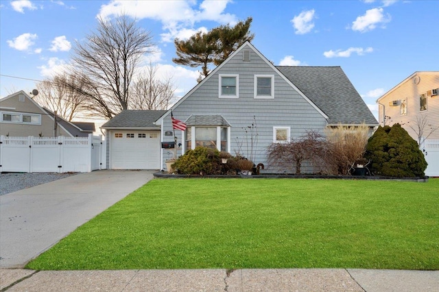 view of front of house with driveway, an attached garage, a front yard, and fence