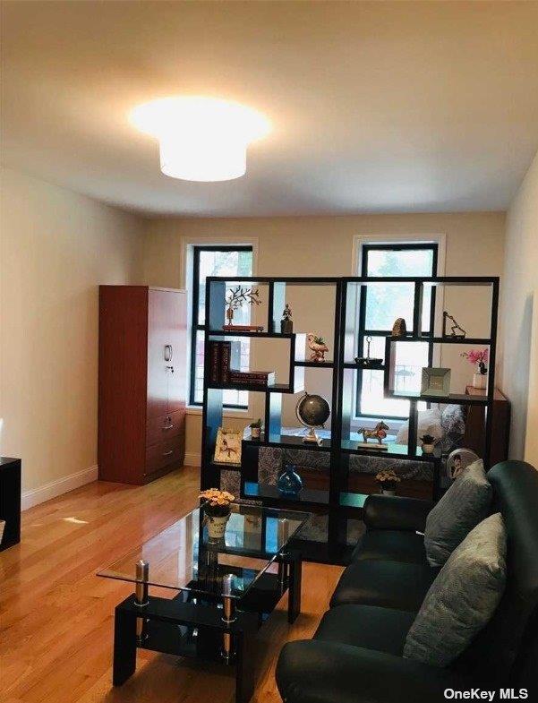 living area with wood finished floors and baseboards