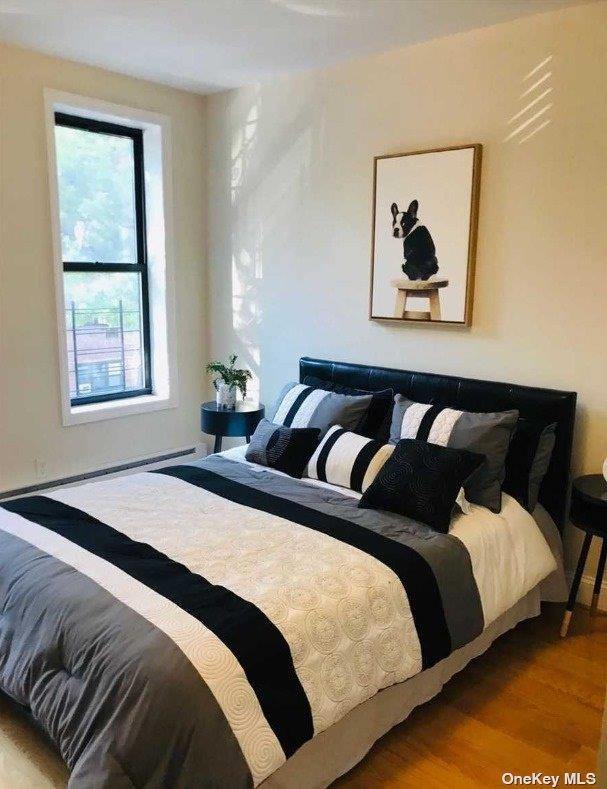 bedroom featuring wood finished floors