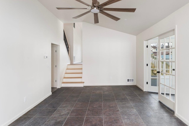 unfurnished room featuring ceiling fan, visible vents, baseboards, stairs, and vaulted ceiling