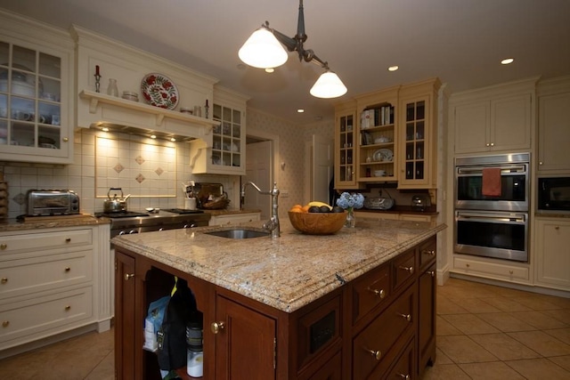 kitchen with black microwave, open shelves, stainless steel double oven, and a sink