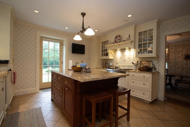 kitchen with ornamental molding and wallpapered walls