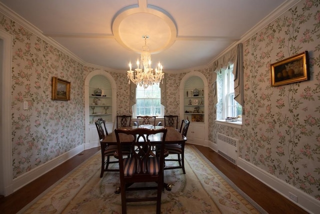 dining space featuring radiator, wallpapered walls, and wood finished floors