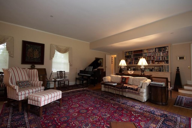 living area featuring crown molding, stairs, and wood finished floors