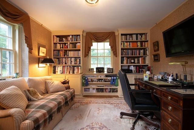 office with plenty of natural light, ornamental molding, built in features, and a textured wall