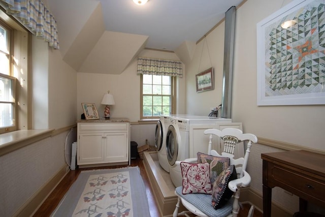 washroom with cabinet space, baseboards, dark wood finished floors, and washer and dryer