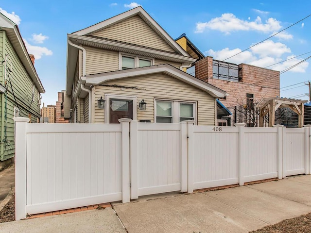 view of front facade with a fenced front yard and a gate