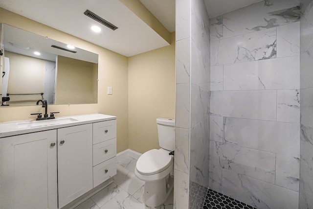 full bathroom with visible vents, toilet, tiled shower, marble finish floor, and vanity