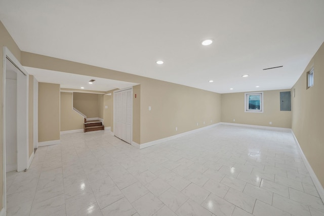 basement with marble finish floor, electric panel, recessed lighting, baseboards, and stairs