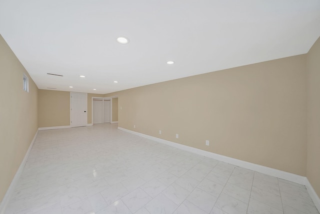 unfurnished room featuring recessed lighting, marble finish floor, and baseboards