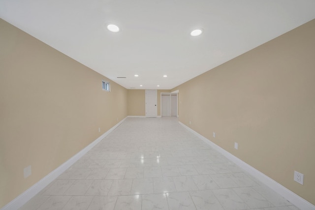 empty room with visible vents, recessed lighting, baseboards, and marble finish floor