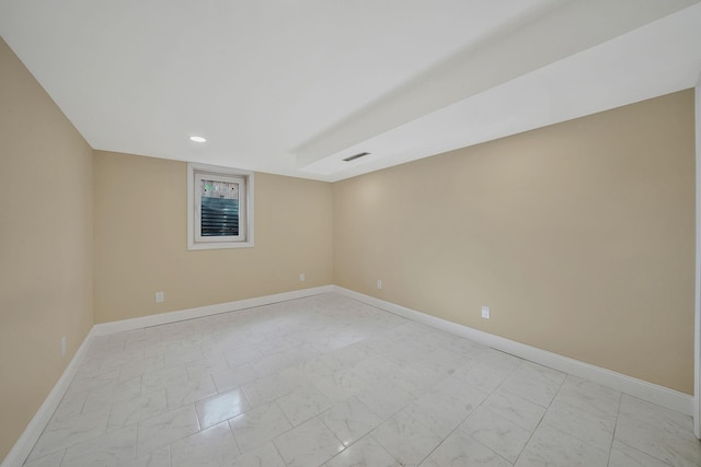 unfurnished room featuring visible vents, baseboards, and marble finish floor