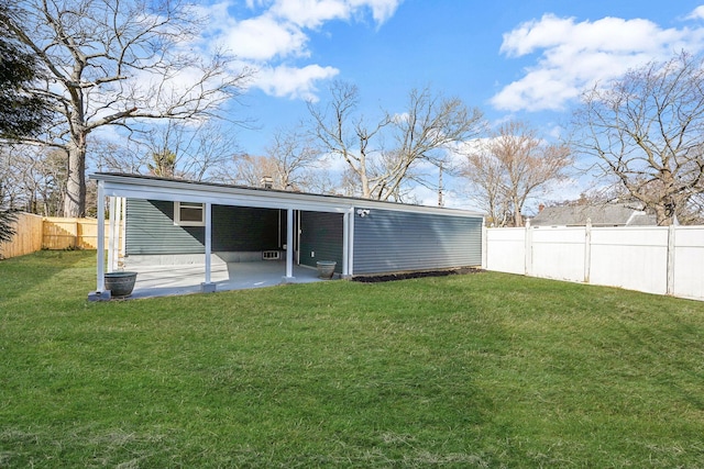 back of house featuring a patio, a lawn, and a fenced backyard