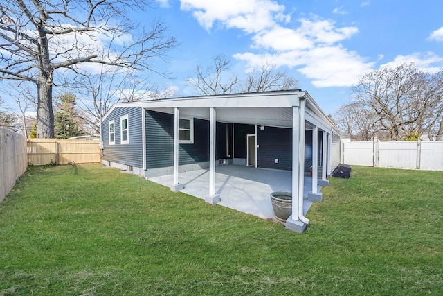 rear view of house with a patio area, a lawn, and a fenced backyard