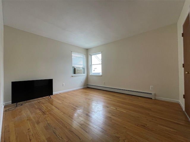 unfurnished living room with cooling unit, wood finished floors, baseboards, and a baseboard radiator