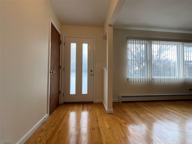 entrance foyer featuring light wood-style floors, baseboards, and baseboard heating