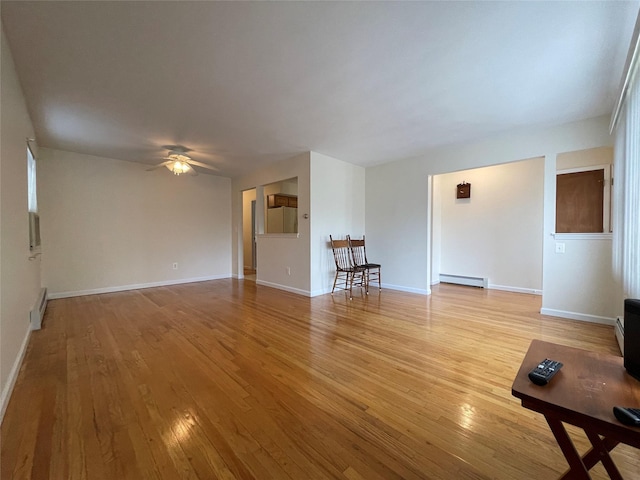 unfurnished living room with baseboard heating, light wood-style flooring, a ceiling fan, and a baseboard radiator