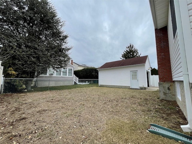 view of yard featuring an outbuilding and fence