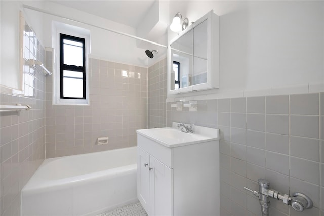 bathroom featuring shower / washtub combination, vanity, tile walls, and tile patterned floors