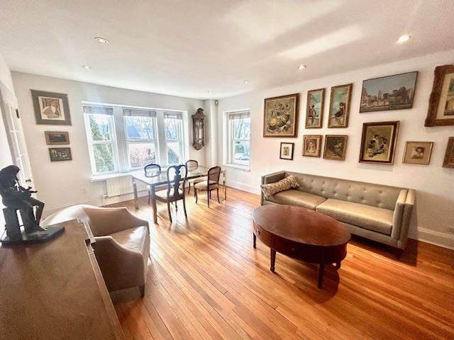 living area with light wood-type flooring and baseboards