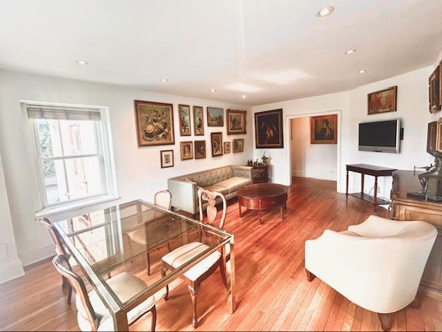 living area with recessed lighting, baseboards, and light wood finished floors