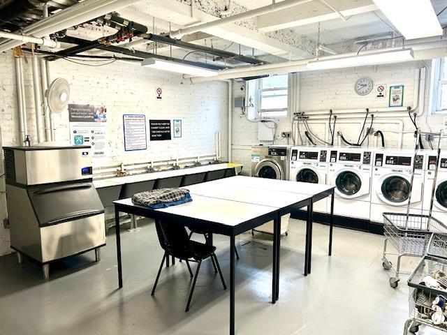 community laundry room with a wealth of natural light and washer and dryer