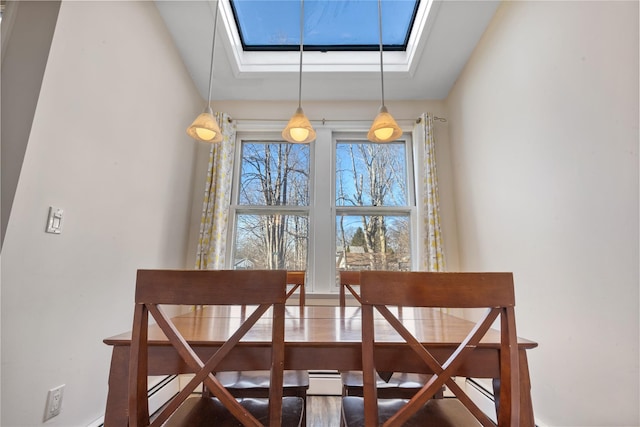 dining room with a skylight and a baseboard radiator