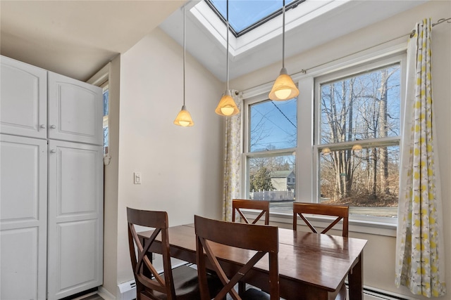 dining room featuring a skylight and a baseboard radiator