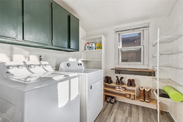 clothes washing area with cabinet space, independent washer and dryer, and wood finished floors