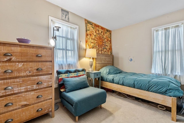 carpeted bedroom featuring multiple windows