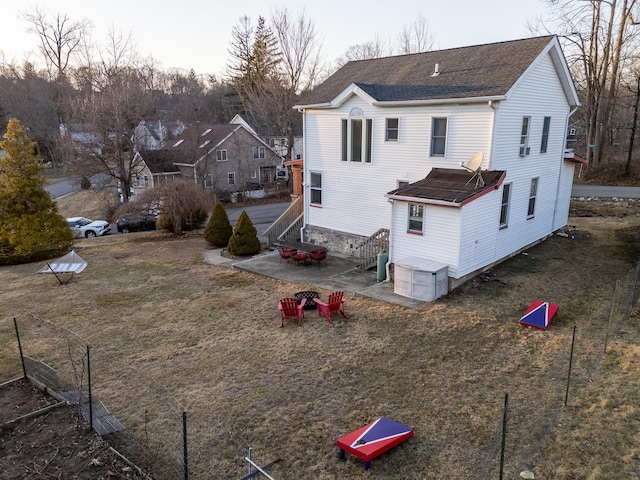 back of house featuring a patio and a shingled roof