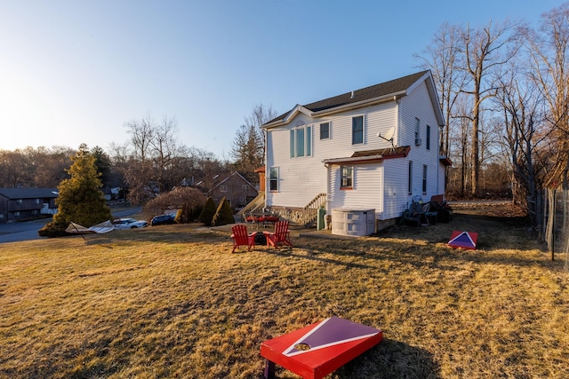 rear view of house featuring a yard