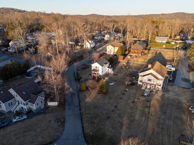 birds eye view of property featuring a forest view and a residential view