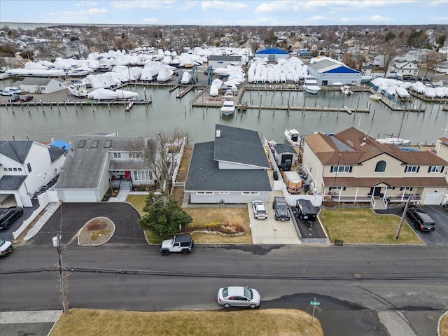 drone / aerial view with a water view and a residential view