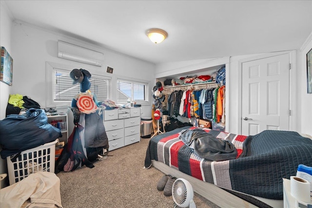bedroom featuring a closet, a wall unit AC, and carpet flooring