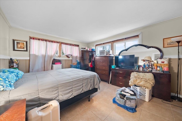 bedroom featuring ornamental molding, multiple windows, and light tile patterned flooring