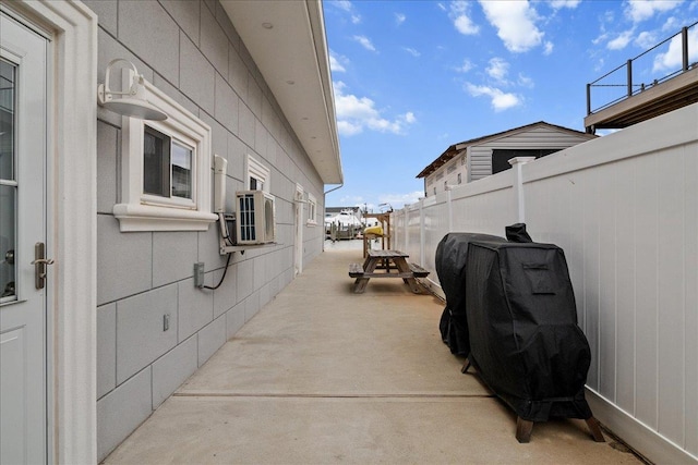 view of side of home with fence, cooling unit, and a patio