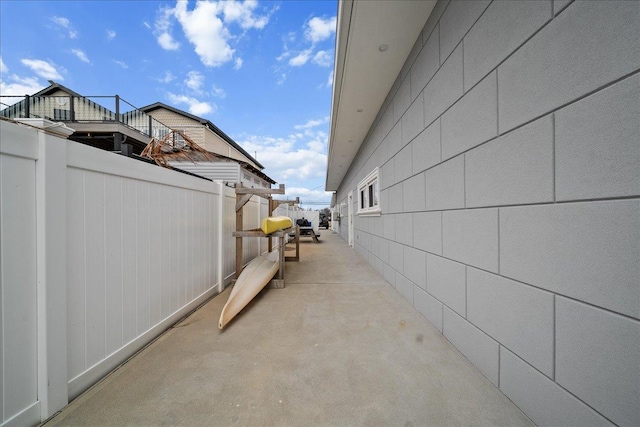 view of side of home with a patio area and fence