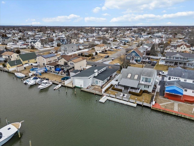 drone / aerial view featuring a water view and a residential view