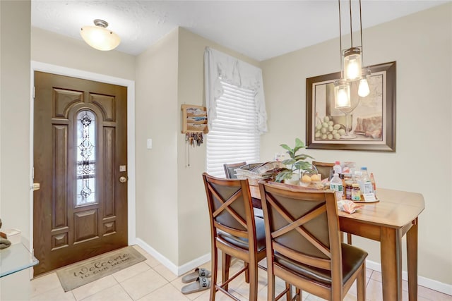 foyer featuring plenty of natural light, baseboards, and light tile patterned flooring