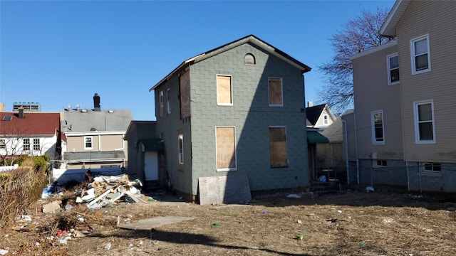 rear view of house featuring entry steps