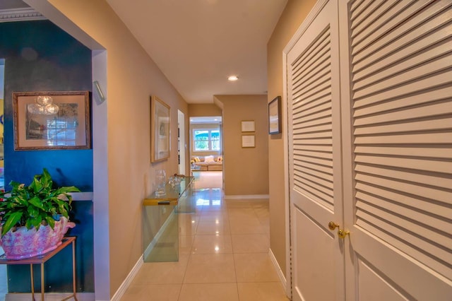 corridor featuring light tile patterned floors, recessed lighting, and baseboards