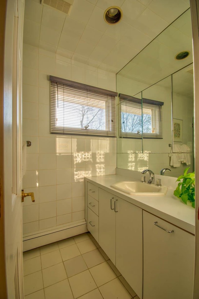 bathroom featuring tile patterned floors, visible vents, tile walls, and vanity