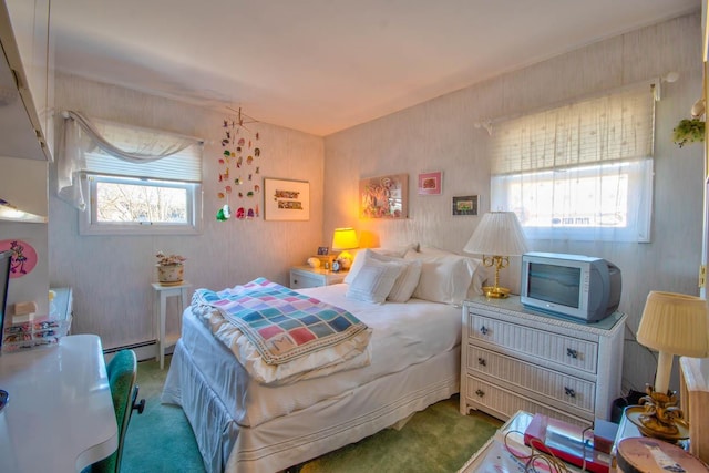 bedroom featuring a baseboard heating unit and carpet floors