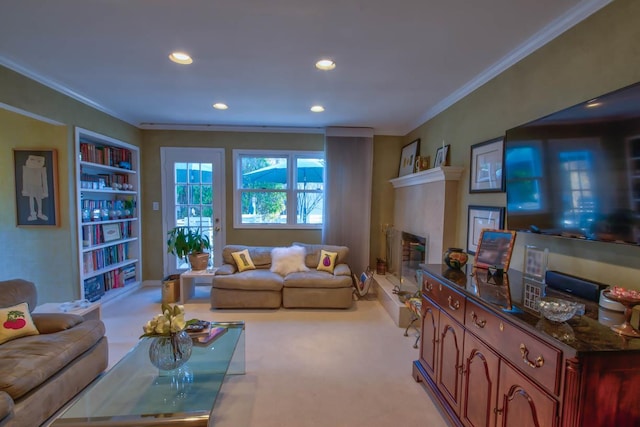 living room with light carpet, a fireplace with raised hearth, built in features, recessed lighting, and crown molding