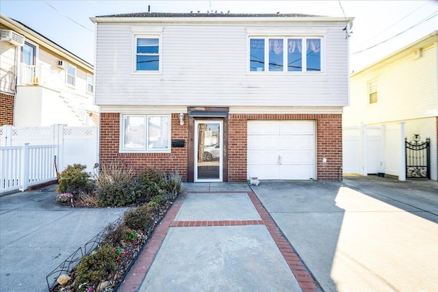 view of front of property featuring concrete driveway, brick siding, and fence