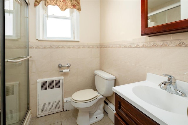 full bath with heating unit, toilet, vanity, tile patterned floors, and a shower with door